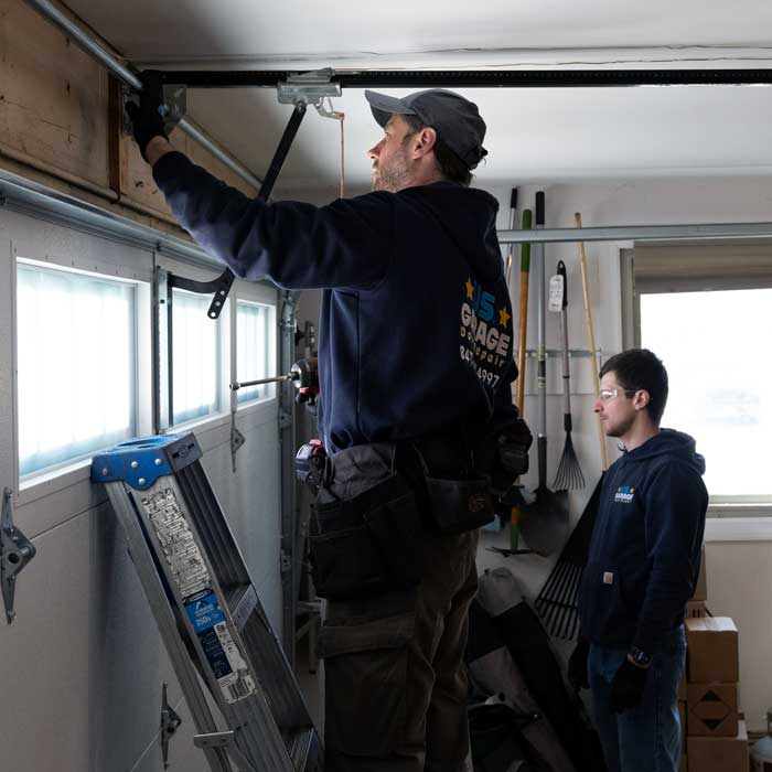 Two USGDR technician fixing garage door near Lake Villa IL